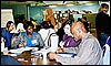 photo of Eunice Abaga (dept of Health), Karen Gatien (dept of Ed) and Allister Johnson discuss project